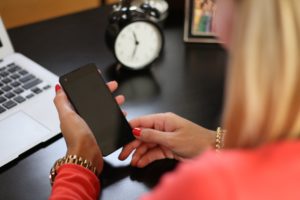 A lady holding a phone