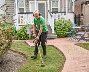 man in green t-shirt holding a shovel